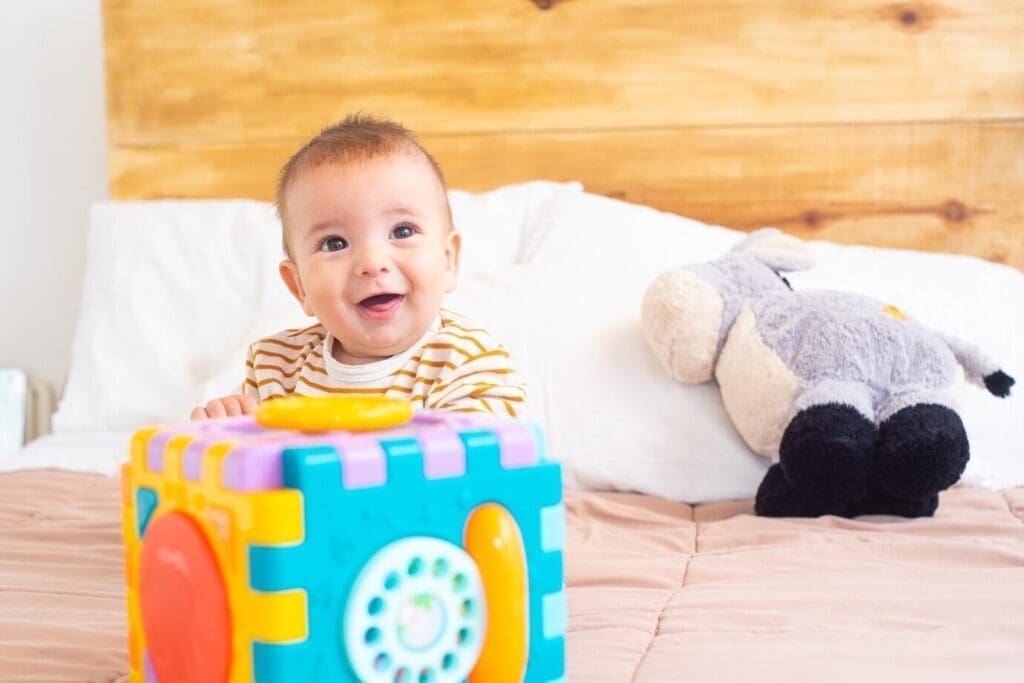 happy baby playing with a toy