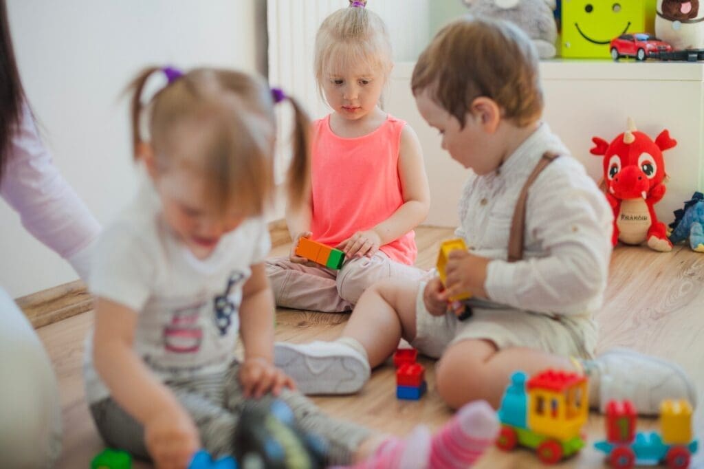 Toddlers Playing Blocks and Cars