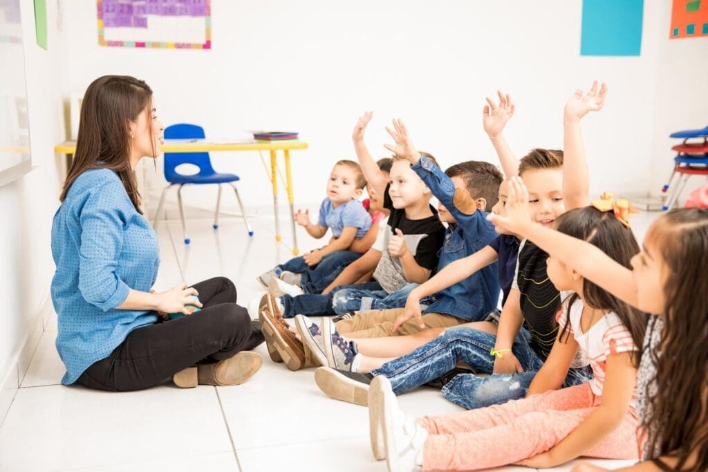 Group of Preschool Students Raising Their Hands
